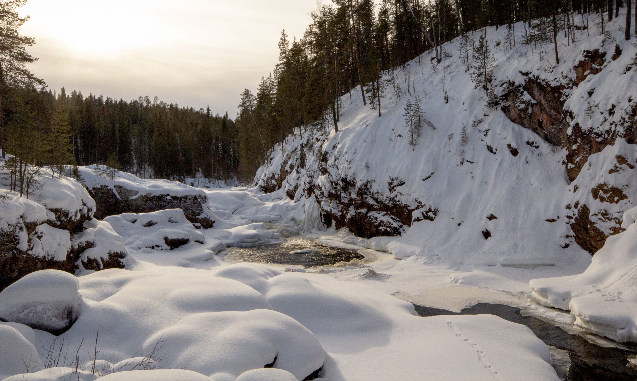 Partly frozen Kiutaköngäs Rapids in the winter