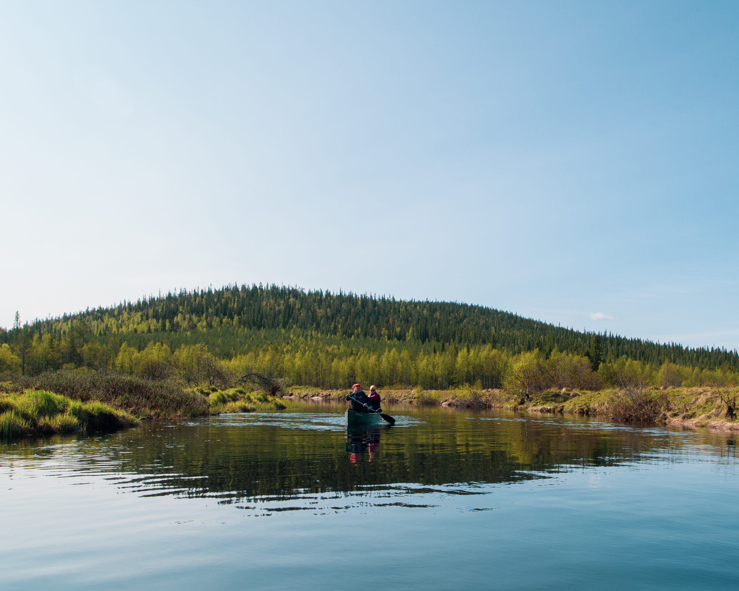 Two kayakers paddling on Parjanjoki river
