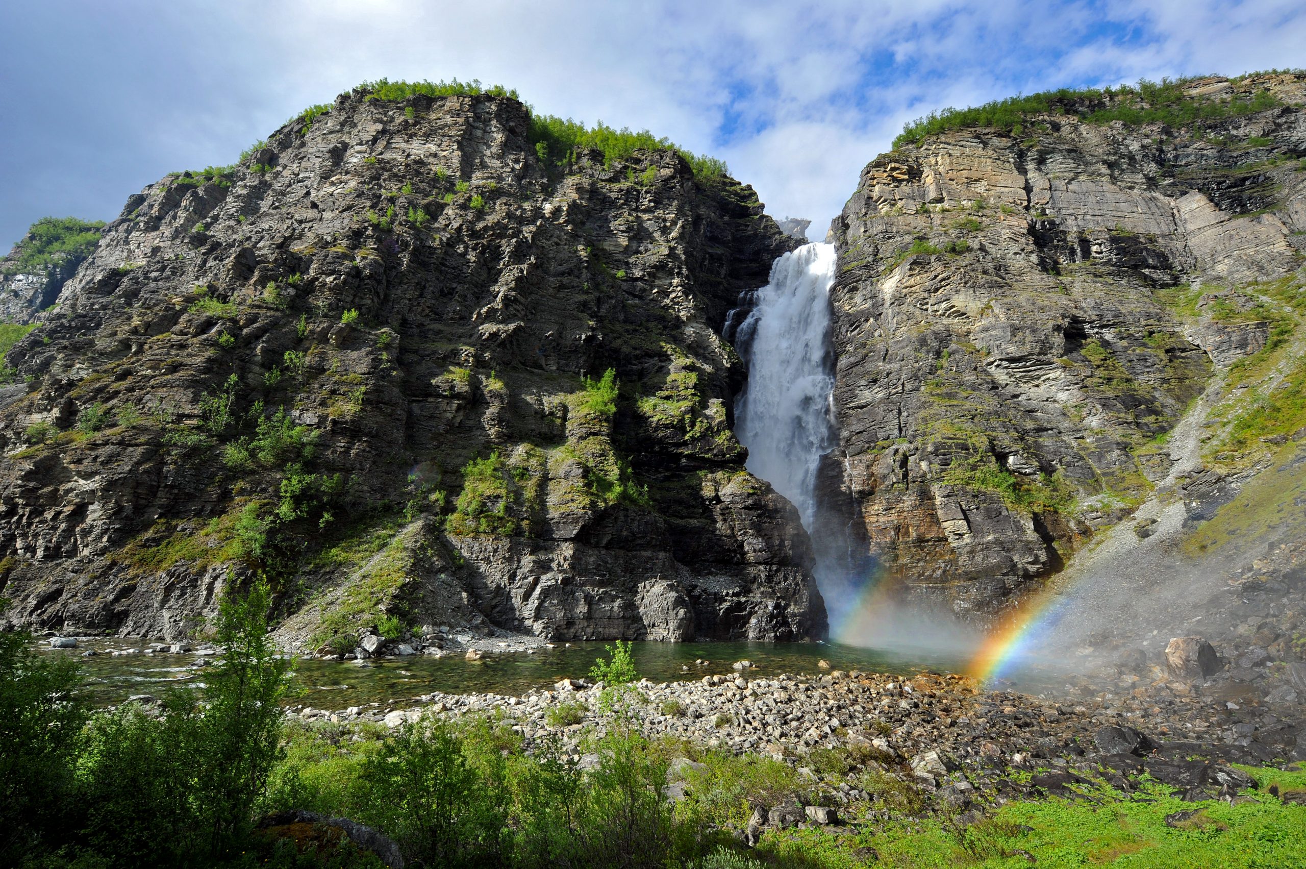 A waterfall running down a steep rocky wall